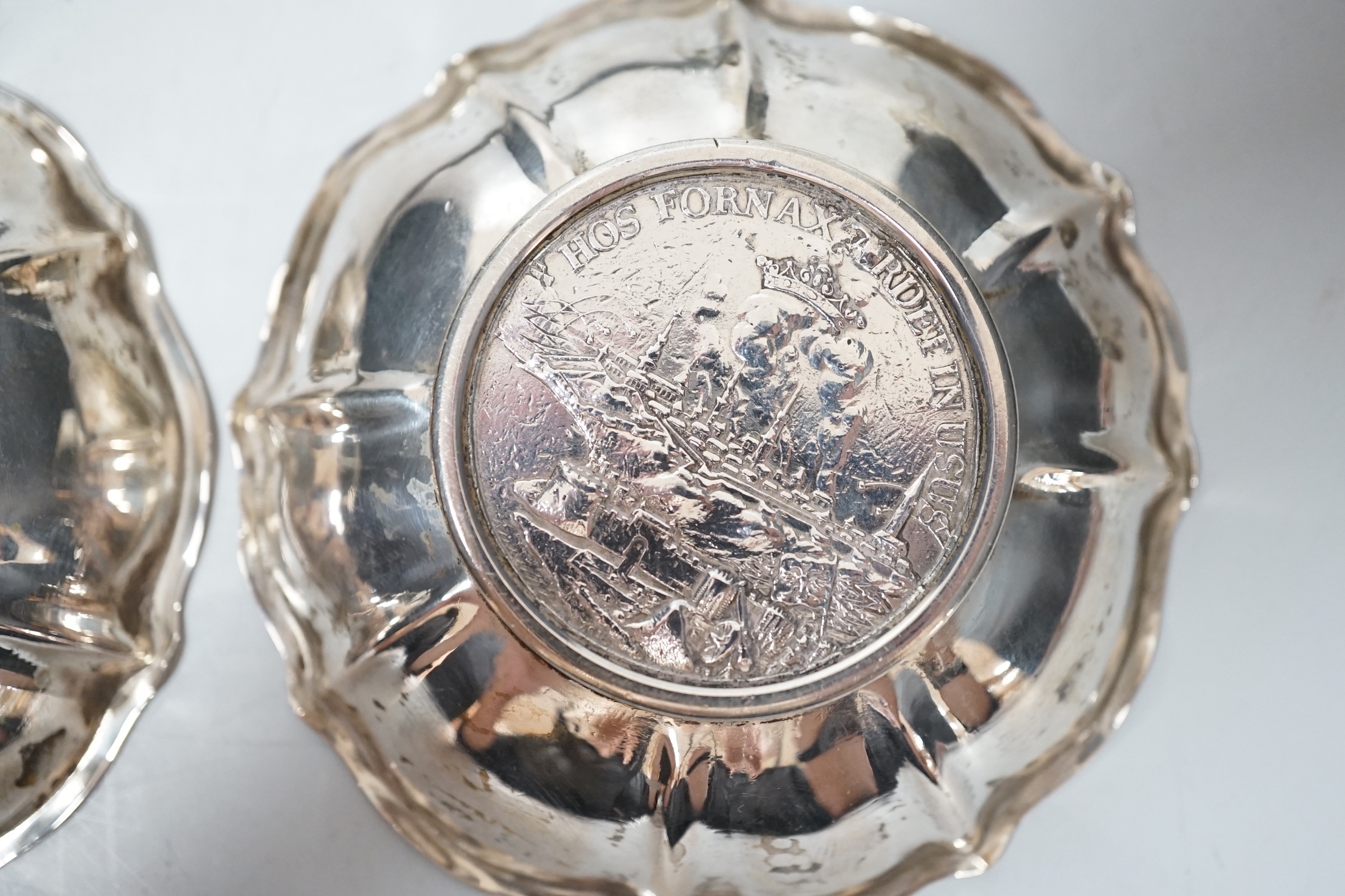 A 20th century Hungarian 800 standard white metal oval platter or stand, 33.2cm, and two 800 white metal bowls with inset coin bases, gross weight 15.5oz.